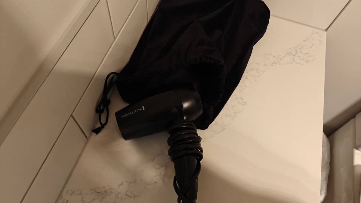 A hairdryer hanging in its bag on the