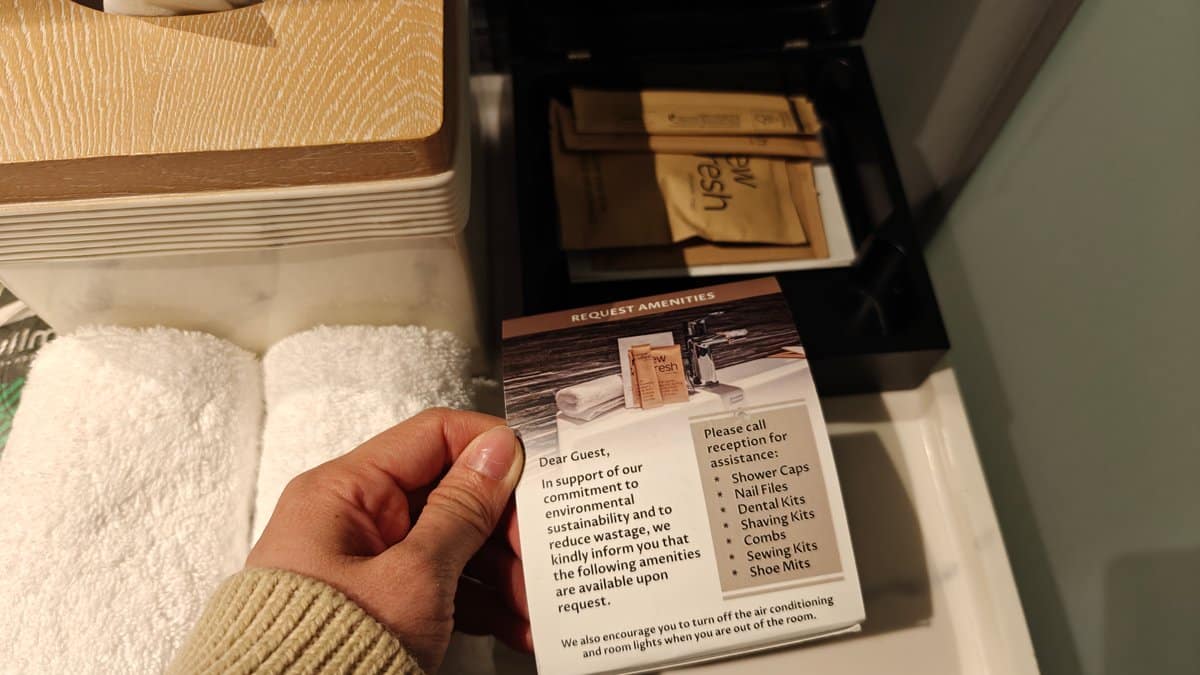 A hand holding a printed card from the