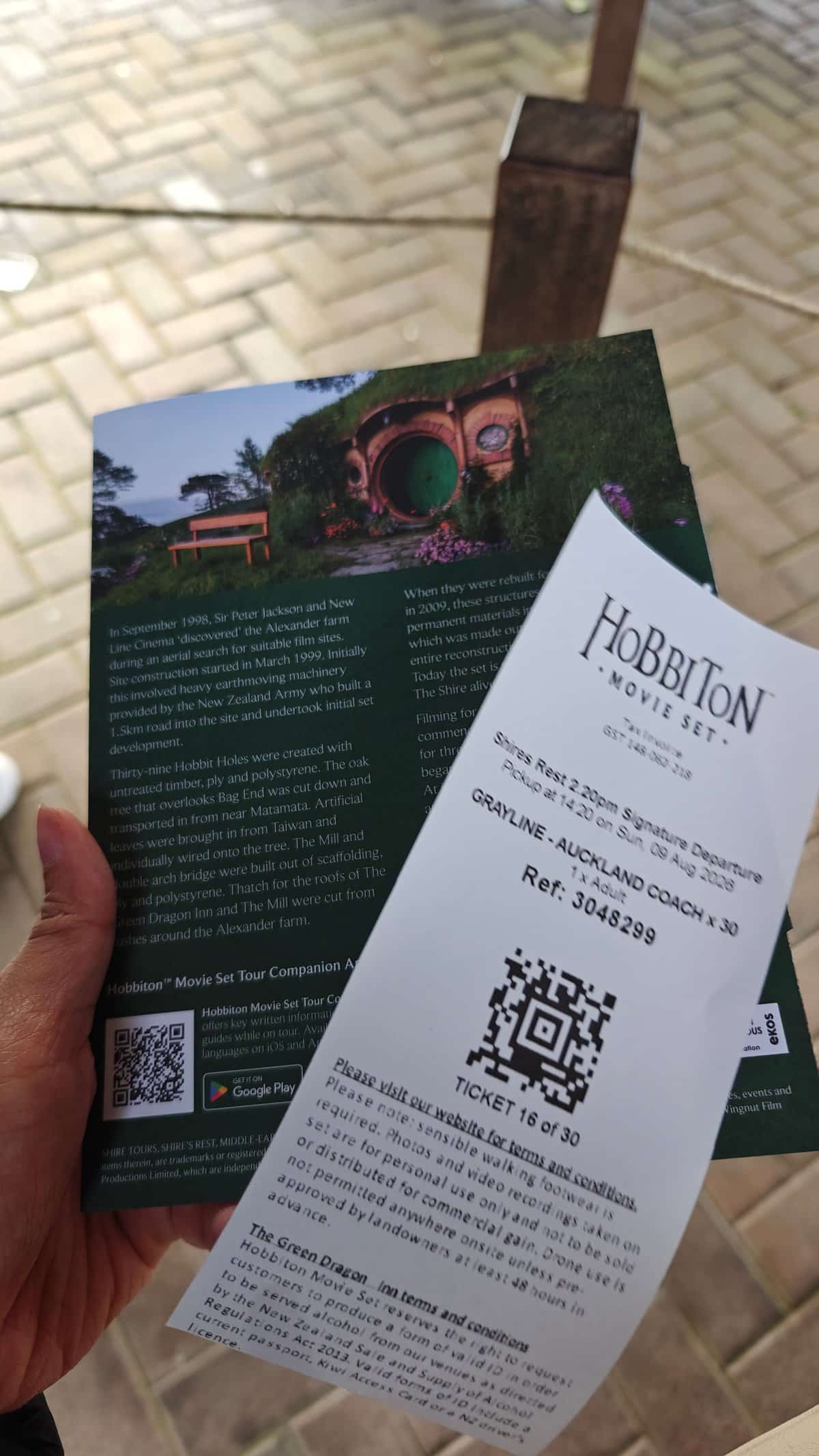 A hand holding the Hobbiton Movie Set ticket
