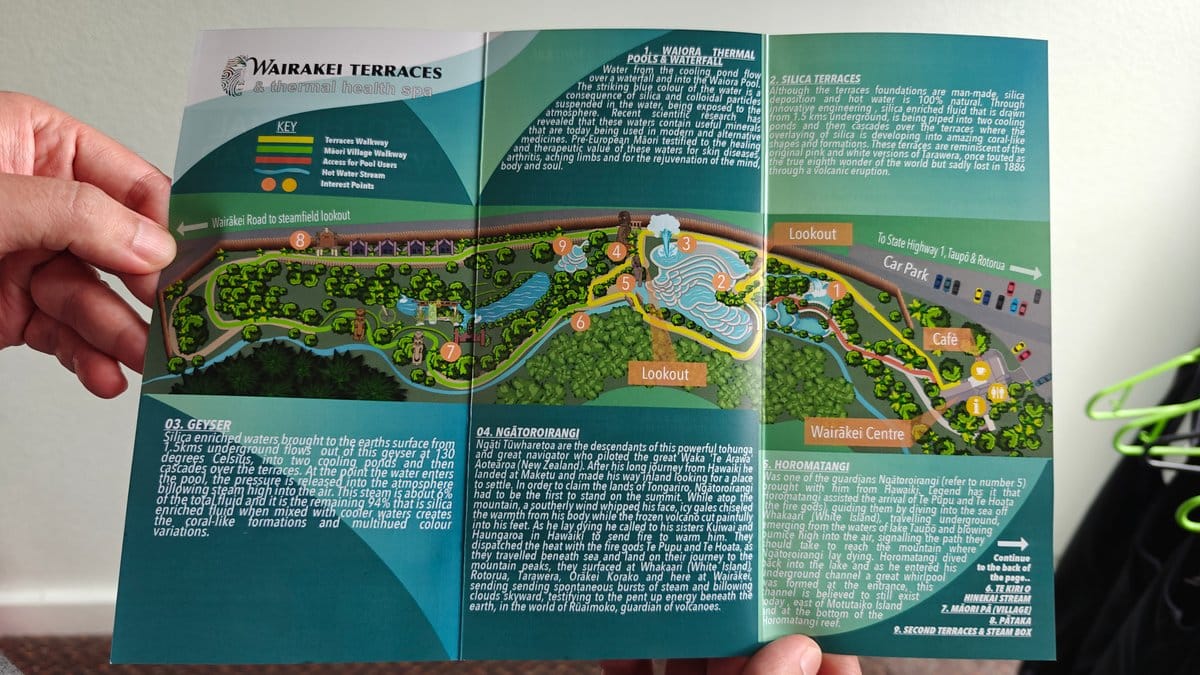 A hand holding the Wairakei Terraces brochure open