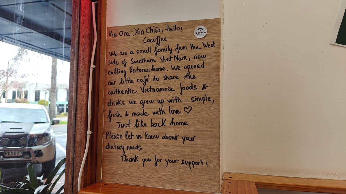 A handwritten notice on a red-painted wall inside