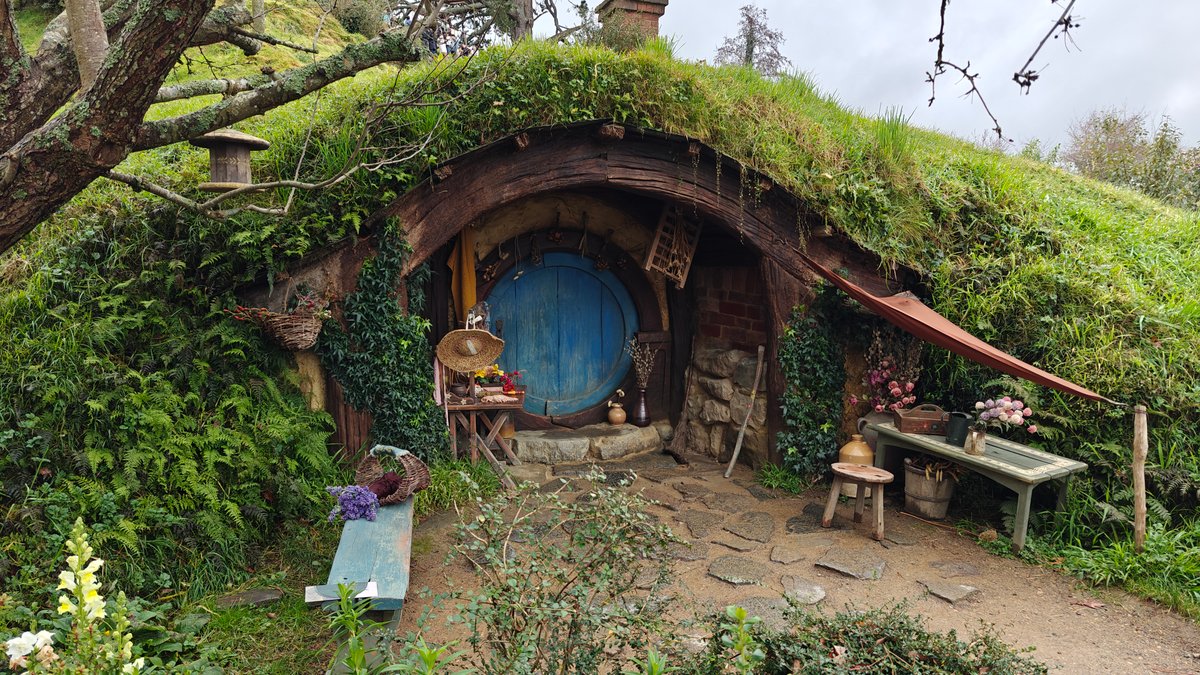 A hobbit hole with a blue door and