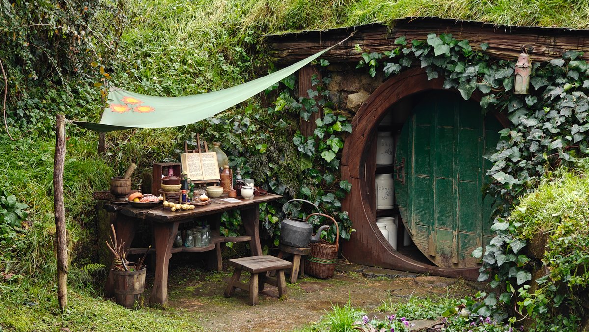 A hobbit hole with a green door and