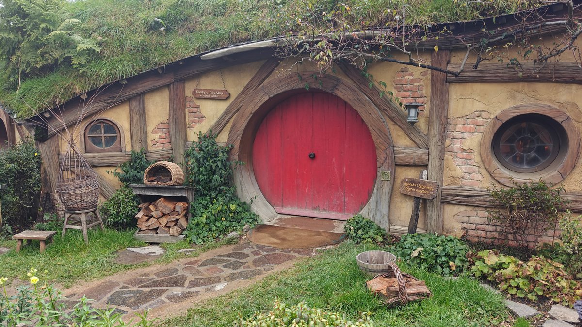 A hobbit hole with a red round door