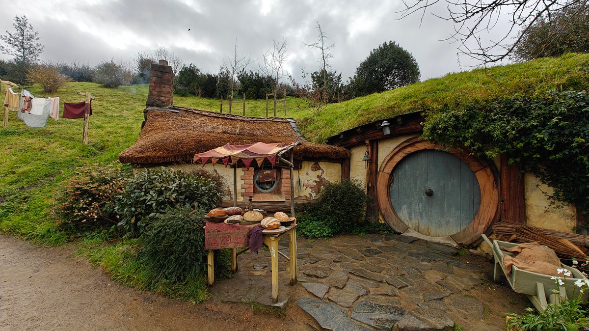 A hobbit hole with a round green door