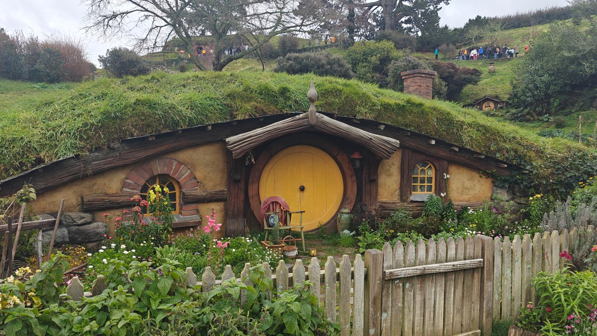 A hobbit hole with a yellow door behind