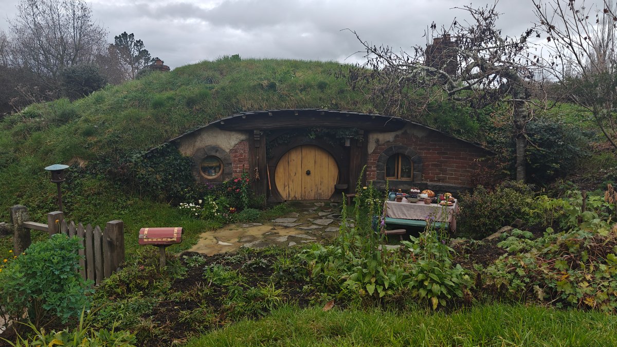 A hobbit hole with a yellow round door