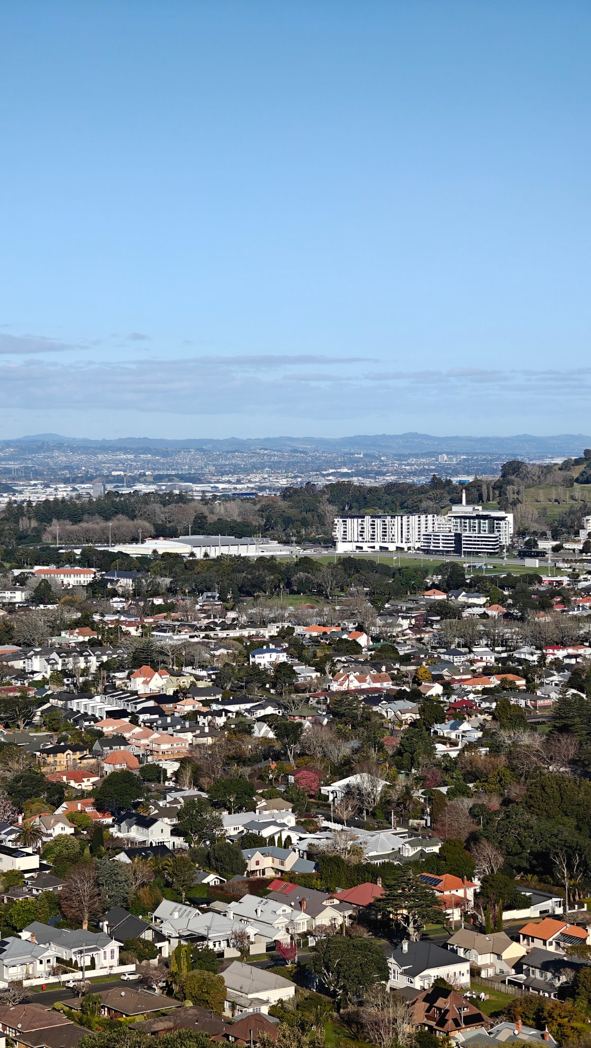 A large white building among the suburbs below.