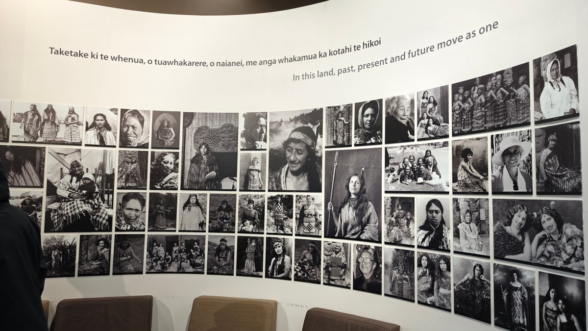 A long wall of black and white portraits
