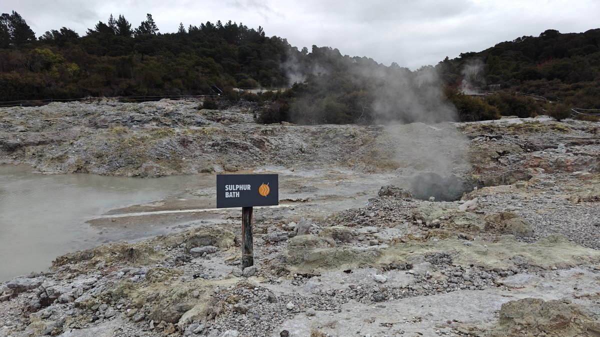 A name plate beside steaming ground with the