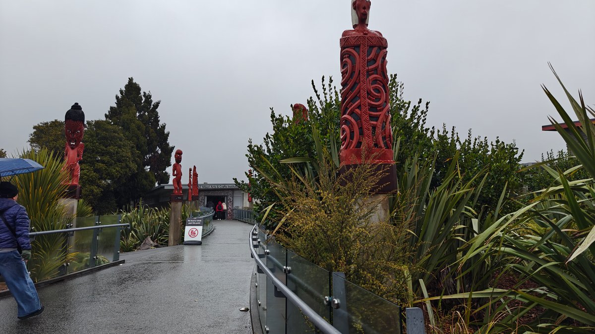 A path lined with carved posts, a visitor