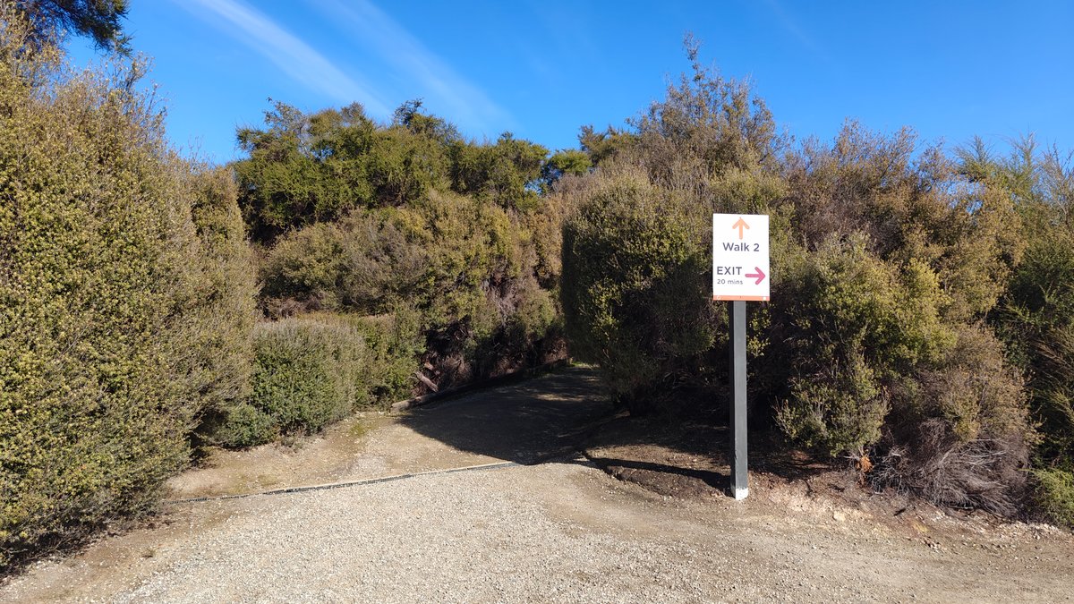 A path with a marker sign at the
