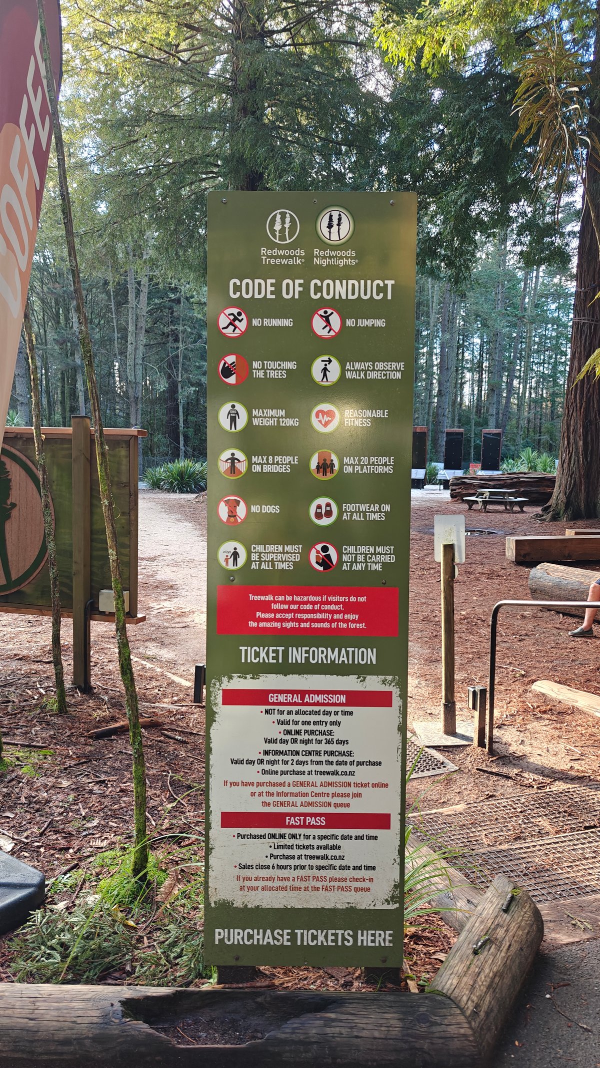 A tall CODE OF CONDUCT pillar with pictograms