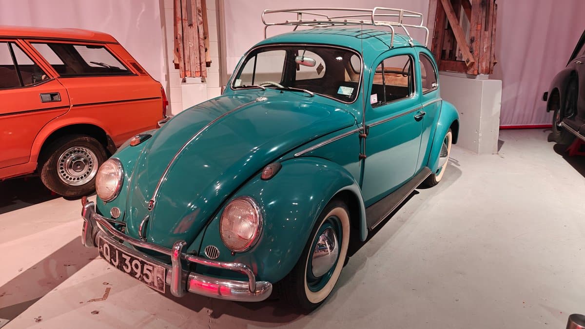 A teal Volkswagen Beetle with the registration DJ3395.
