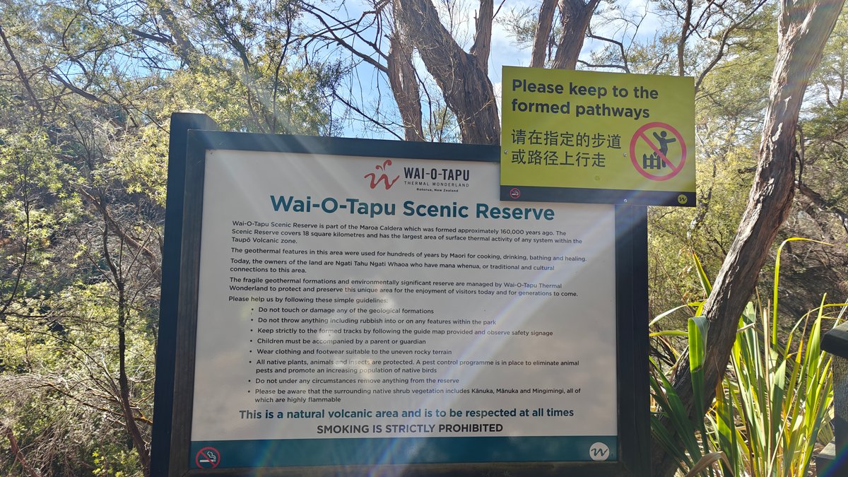 A Wai-O-Tapu Scenic Reserve information board with a