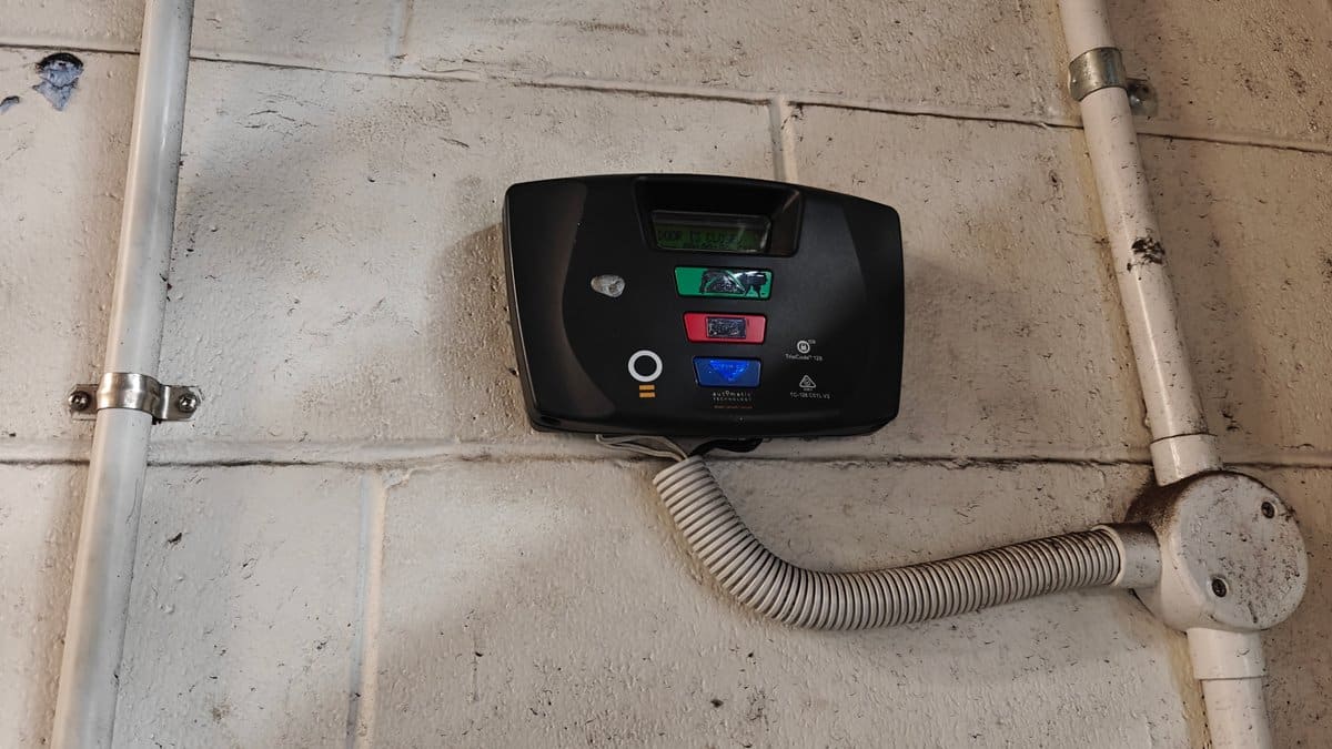 A wall-mounted control unit with its conduit running