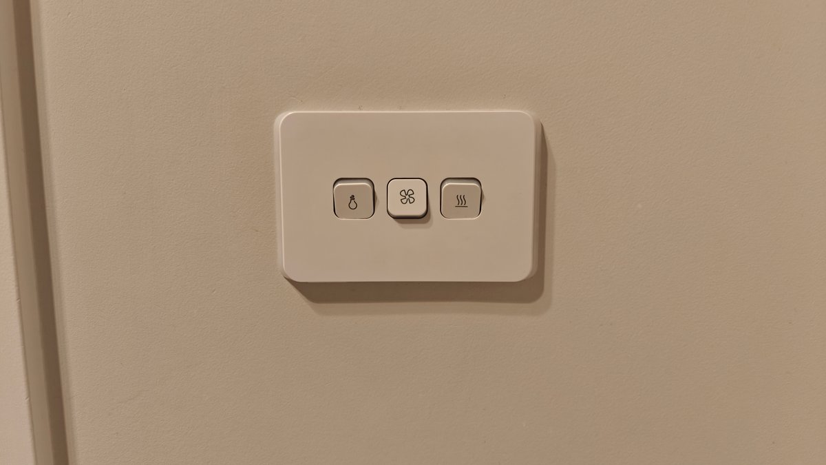 A wall switch plate beside the vanity.