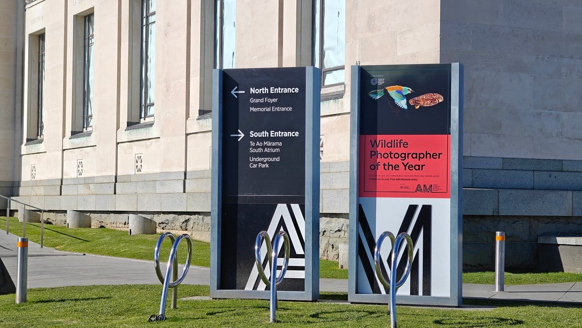 A wayfinding sign giving the North Entrance for