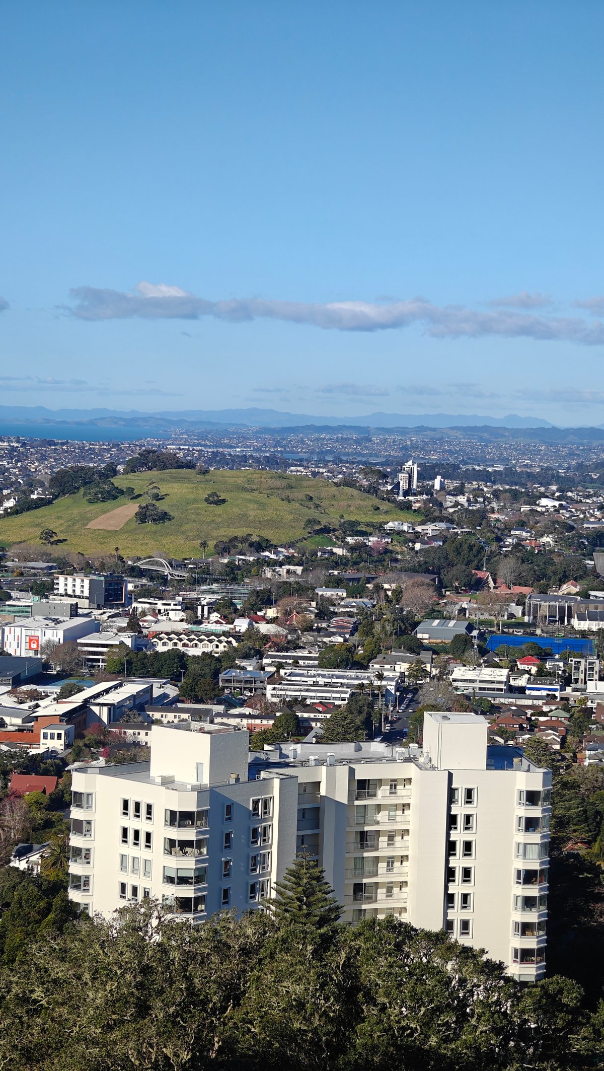 A white apartment building close below the slope