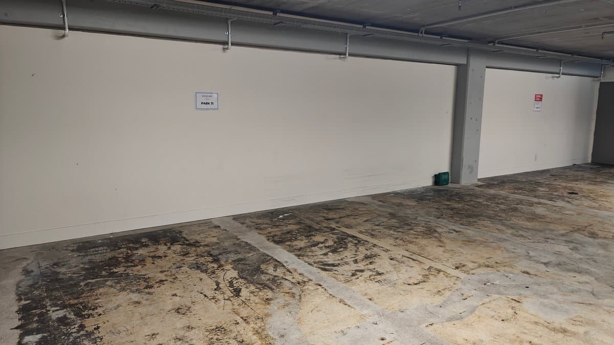 An empty concrete parking bay under the building.