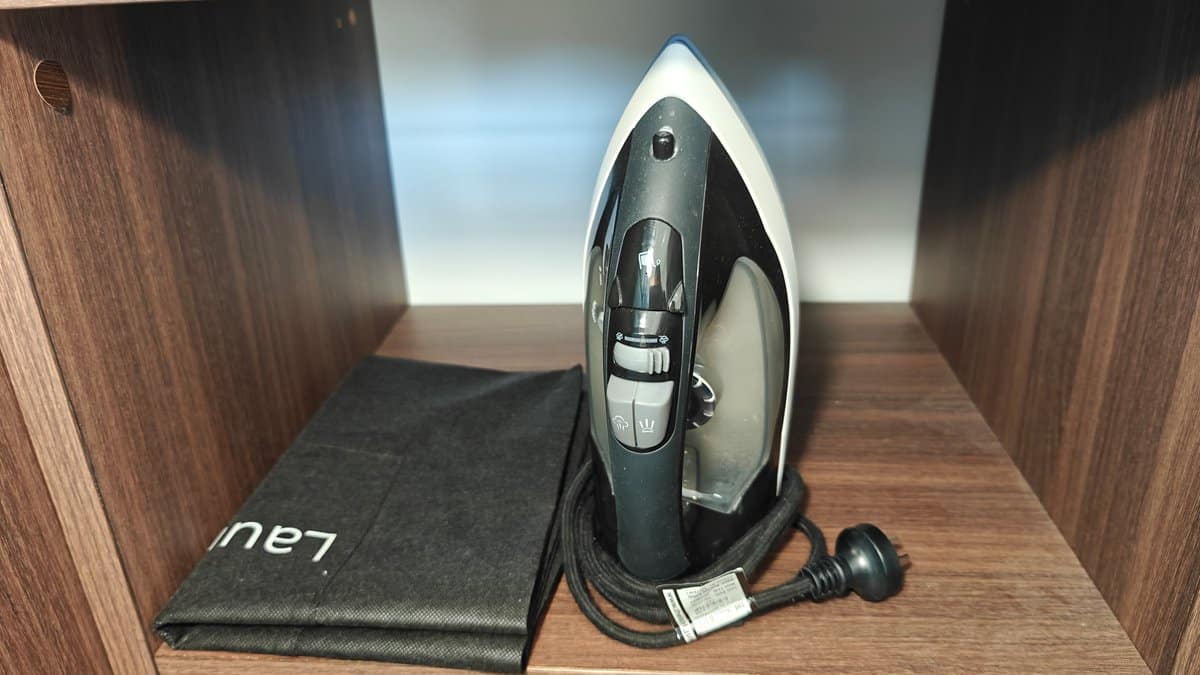 An iron and ironing board stowed in the