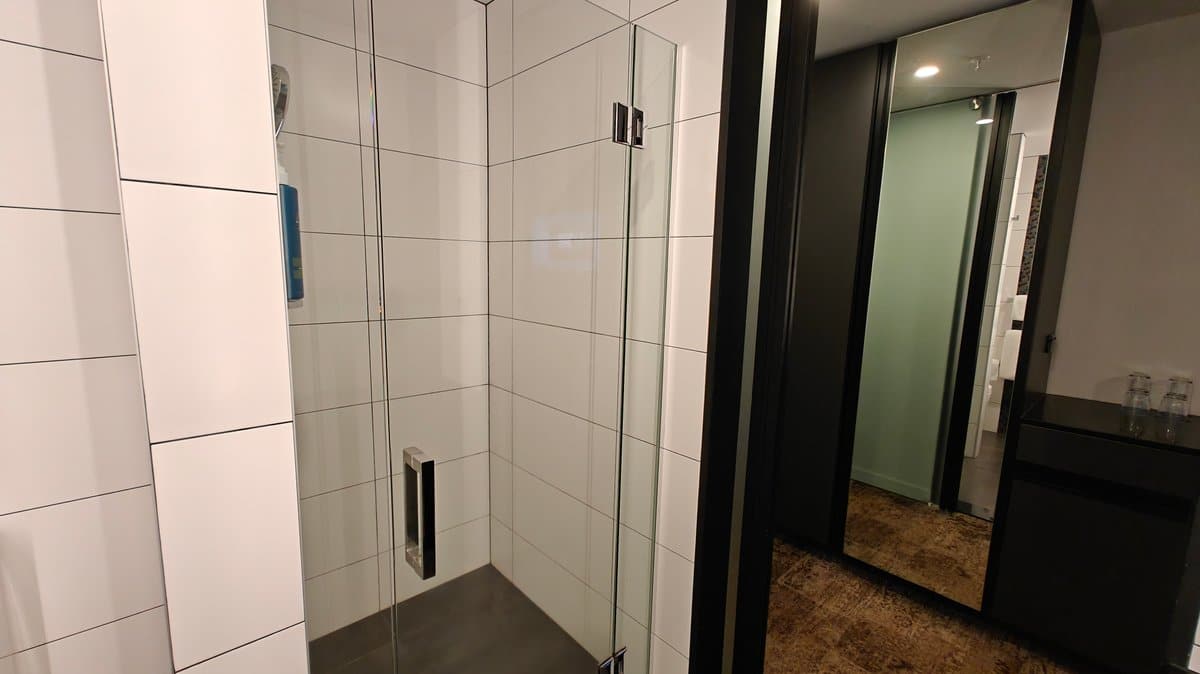 Bathroom mirror reflecting the door