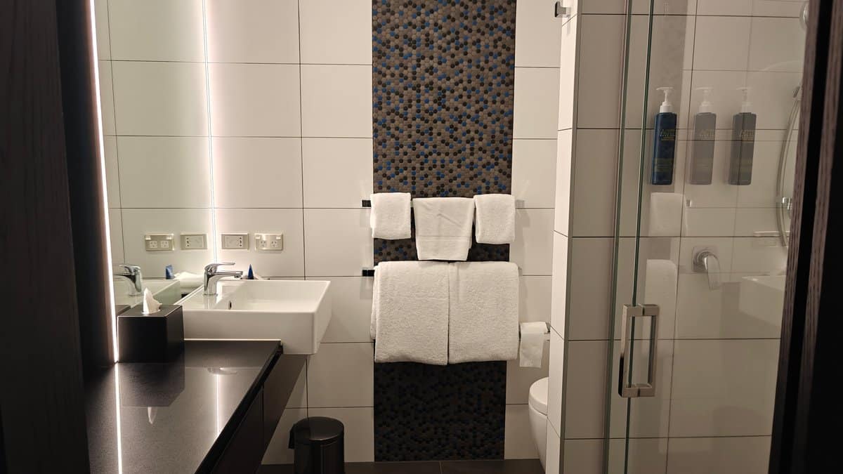 Bathroom with toilet and tiled walls
