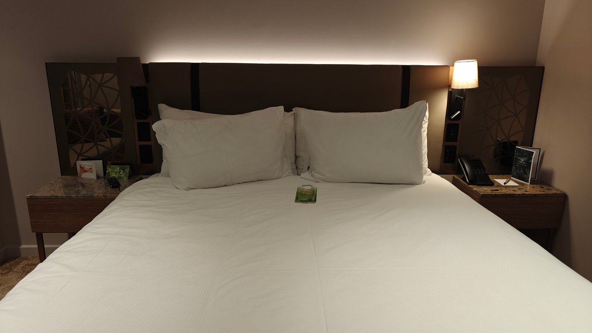 Bed against panelled headboard