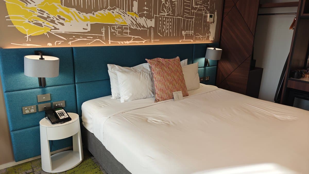 Bedside lamps beneath skyline mural