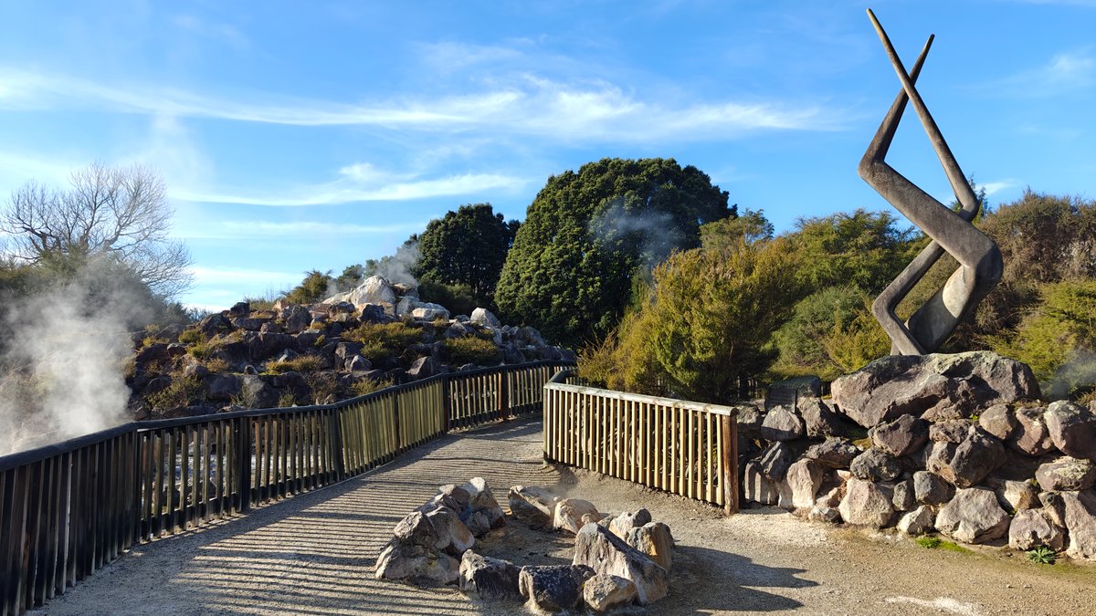 Boardwalk past sculpture and steam