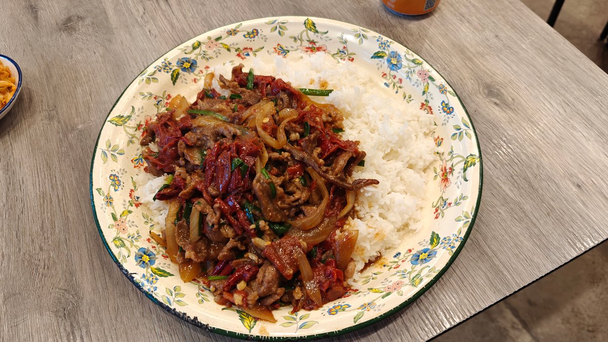 Braised beef strips over steamed rice