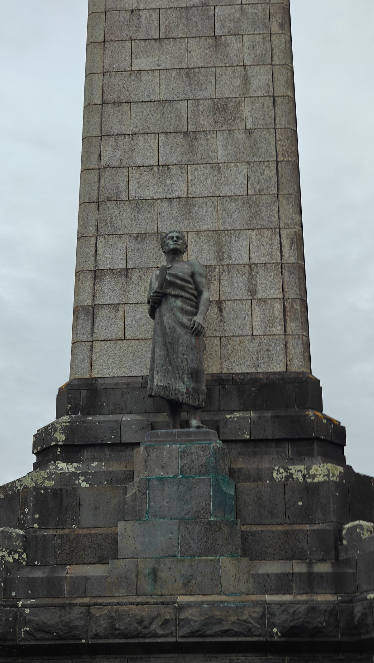 Bronze Māori figure on the plinth