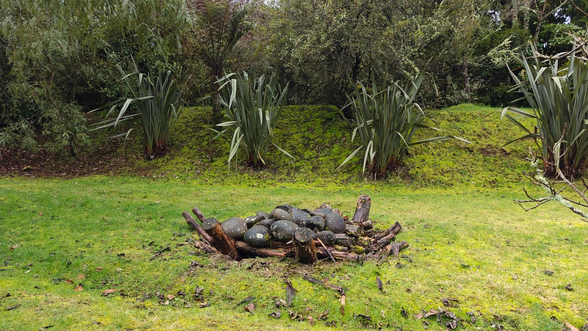 Bronze sculpture among the flax