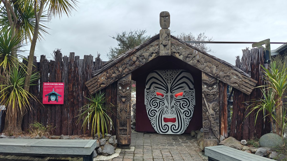 Carved gateway with red-eyed mask