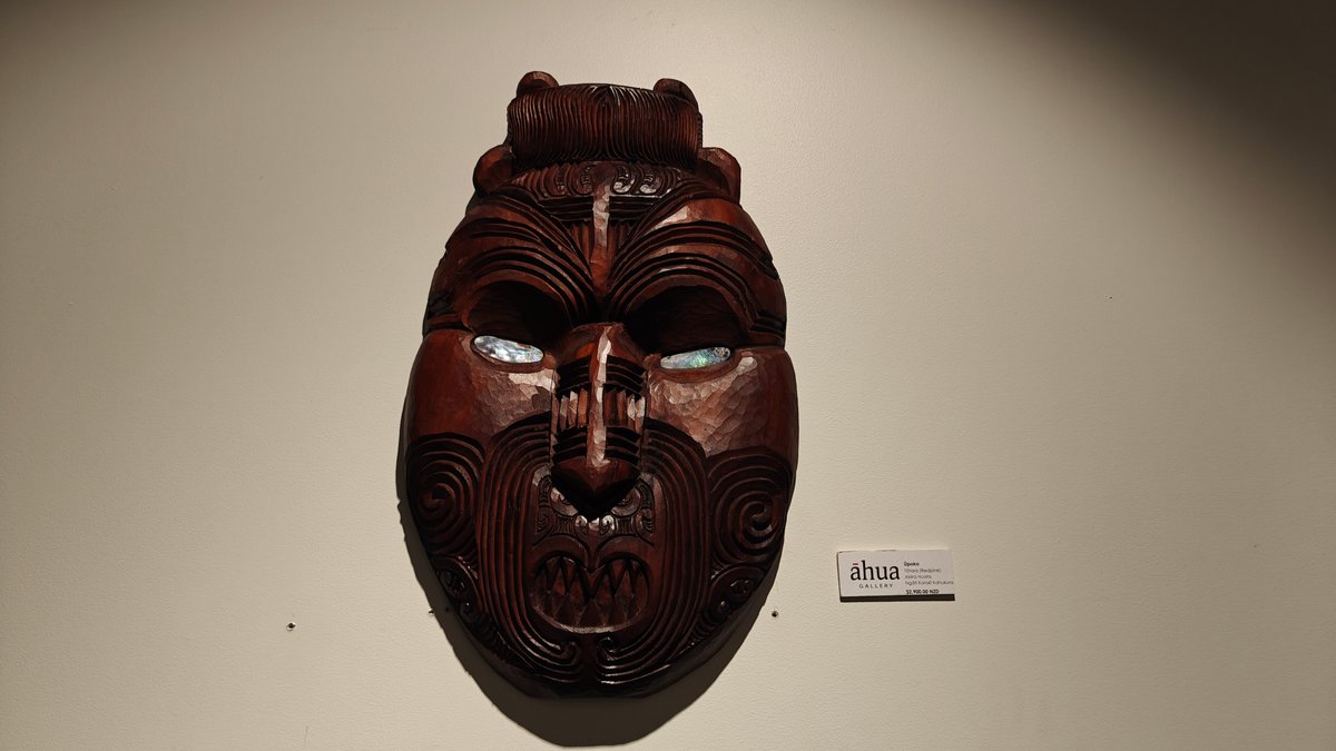 Carved wooden mask on wall