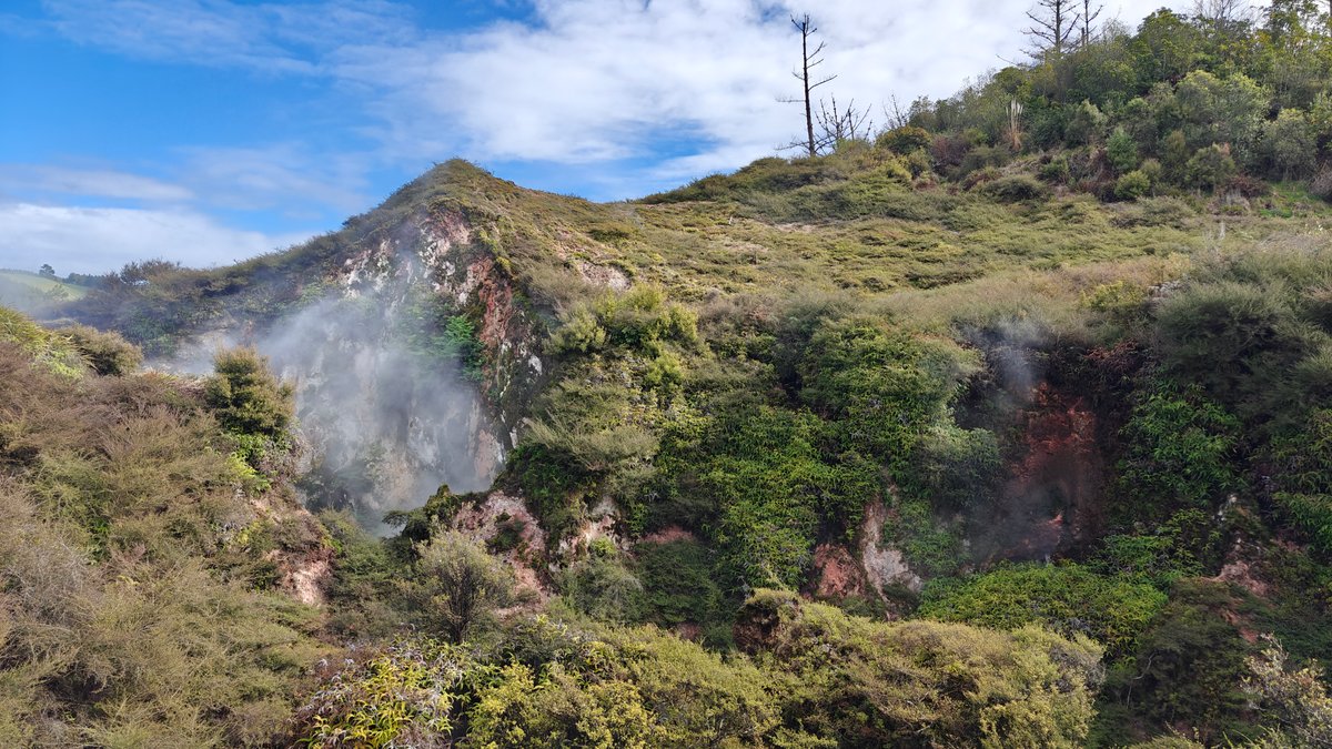 Crater steam and falling green slopes