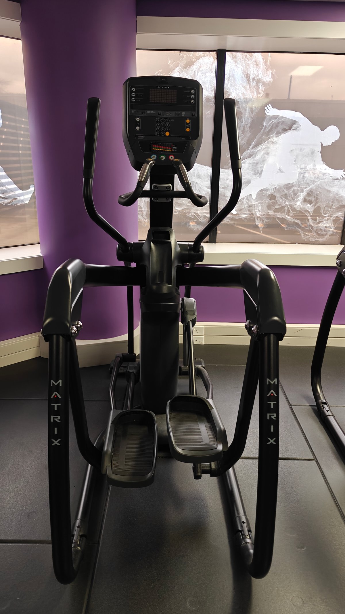 Cross-trainer against the purple wall