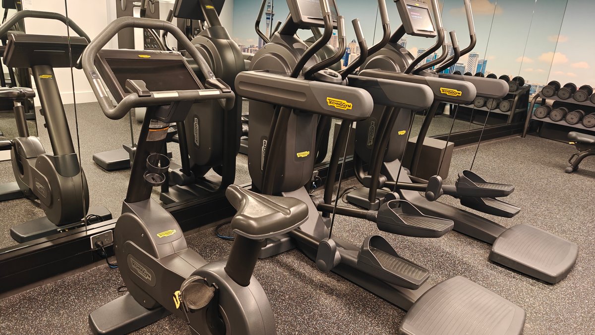 Cross-trainers facing the mirrored wall