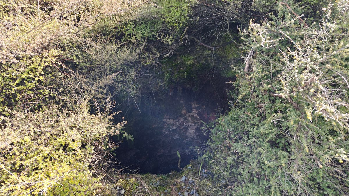 Dark steaming vent beside the track