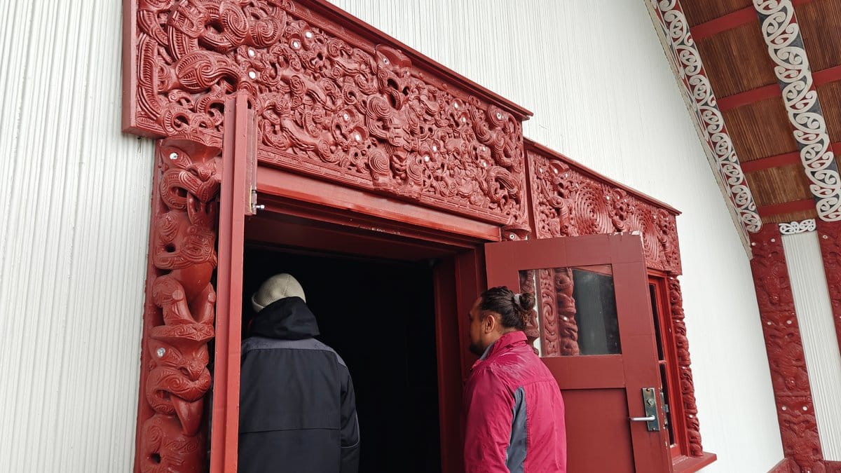 Entering the carved meeting house