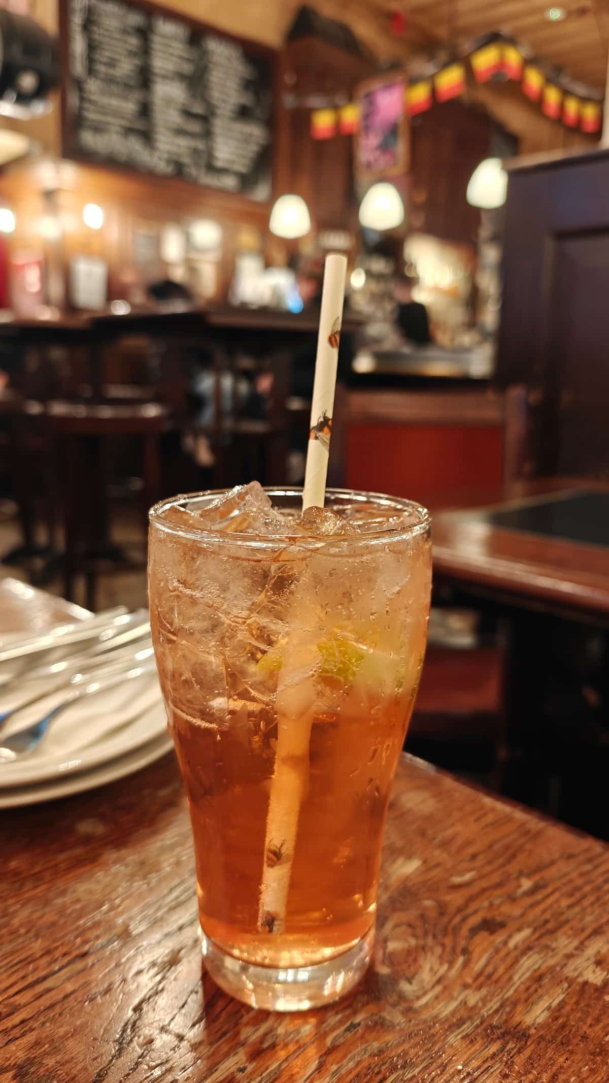 Garnished iced drink with straw