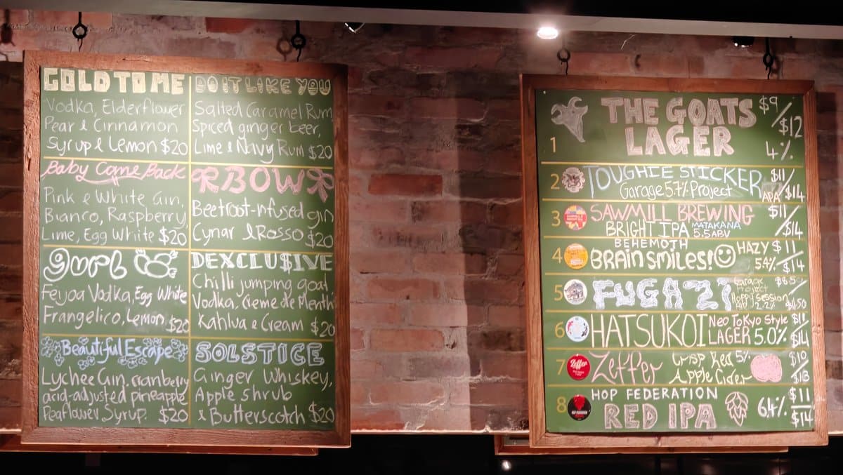 Green chalkboard drinks behind the bar