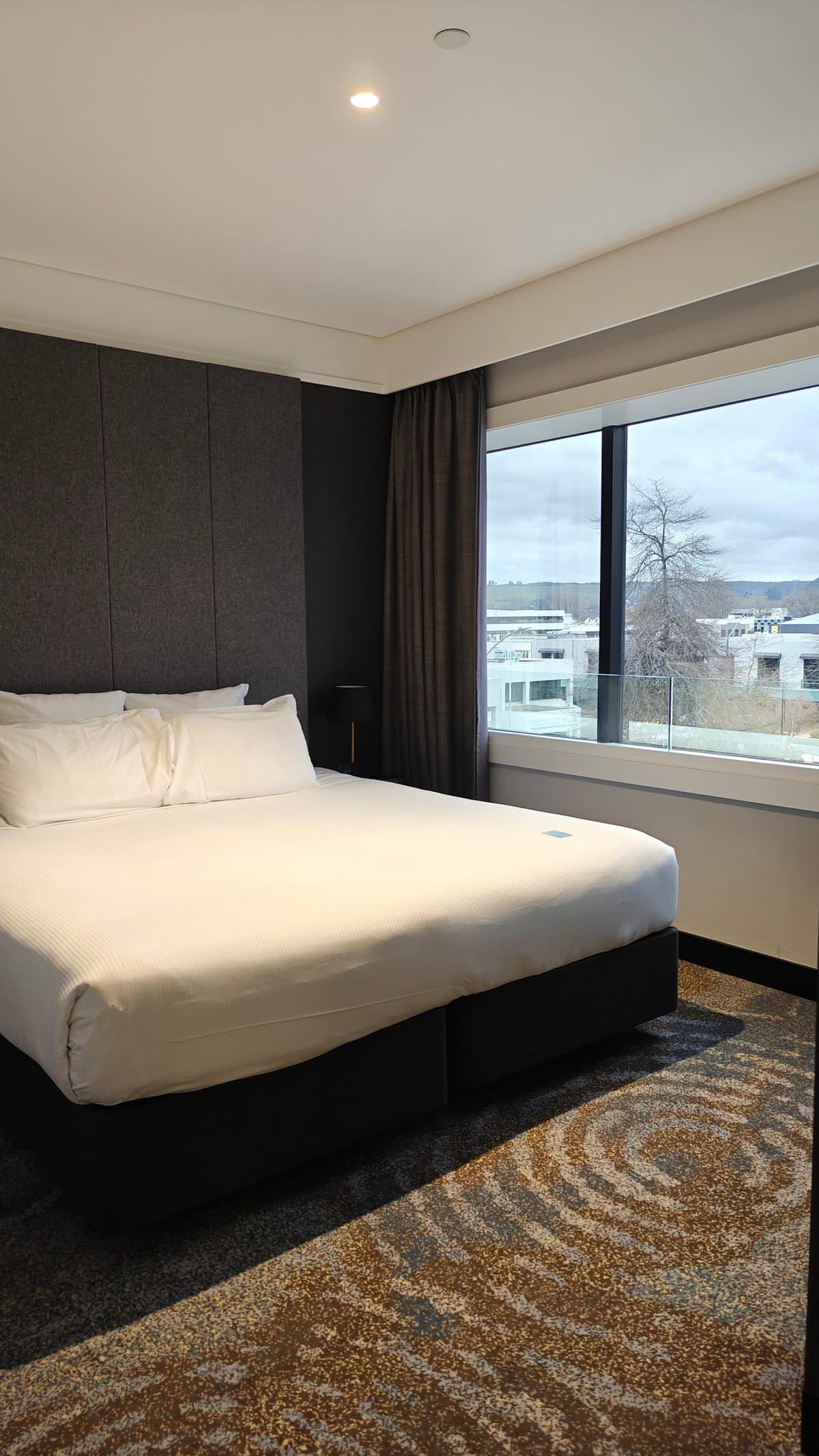 Guest room bed in white linen