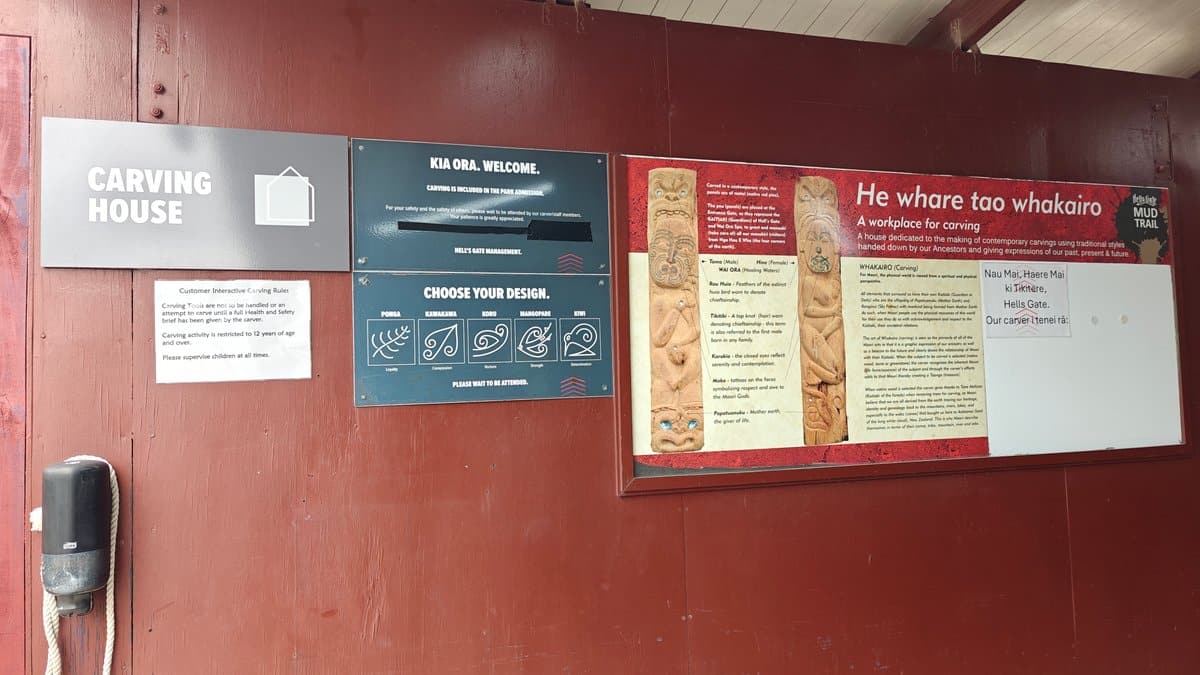 Inside the carving house — panels reading CARVING