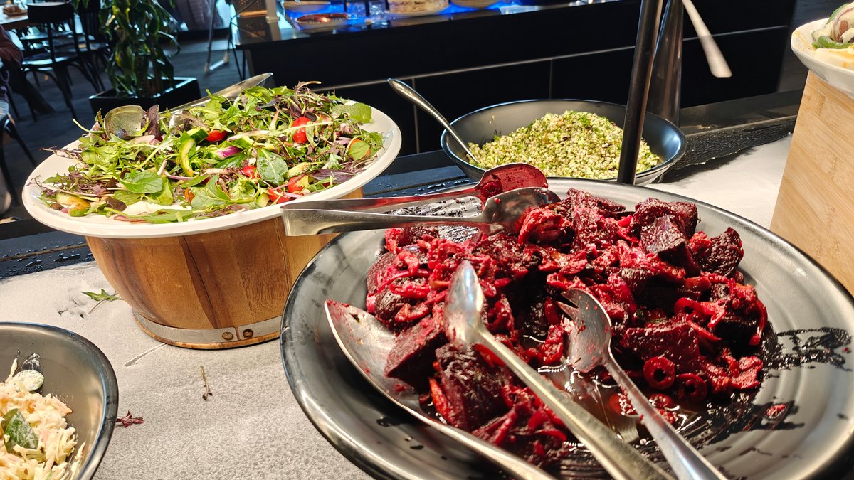 Large bowls of dressed salads