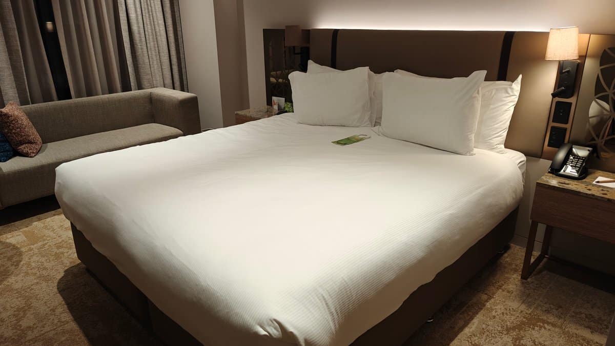 Made bed beside the sofa