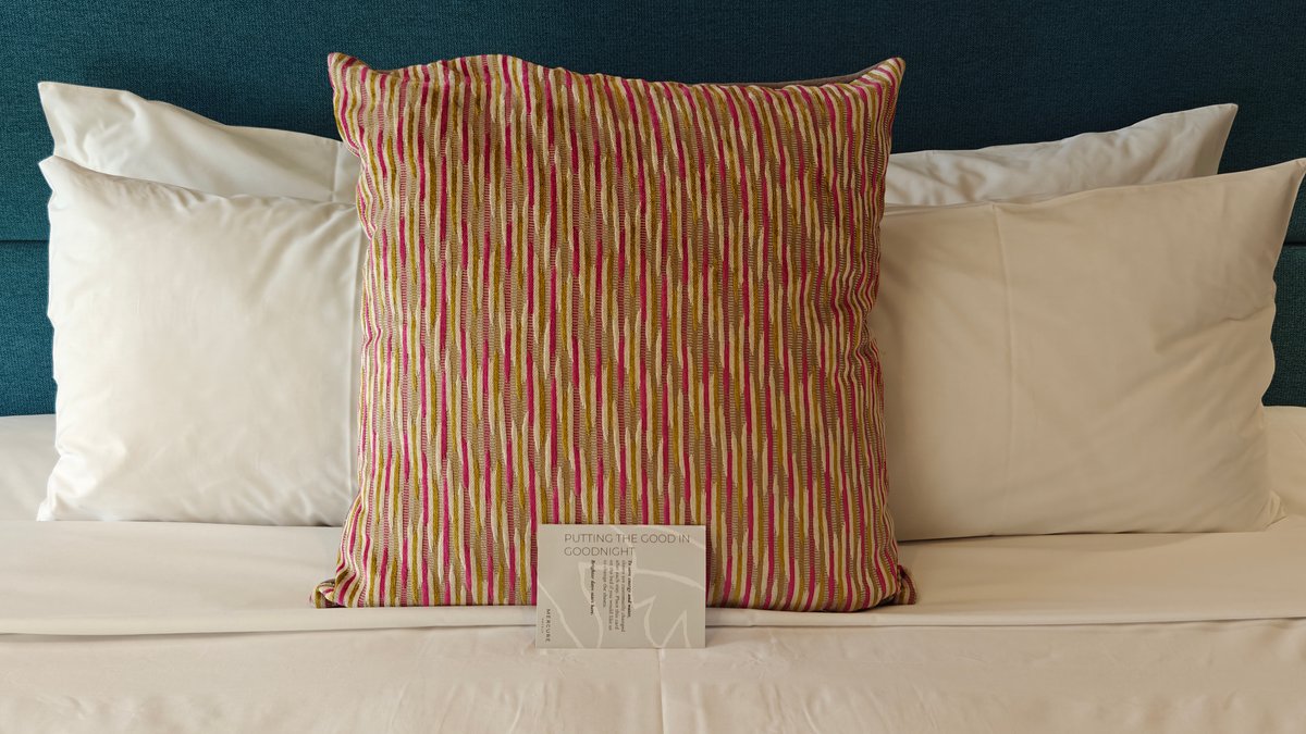 Made bed with striped cushion