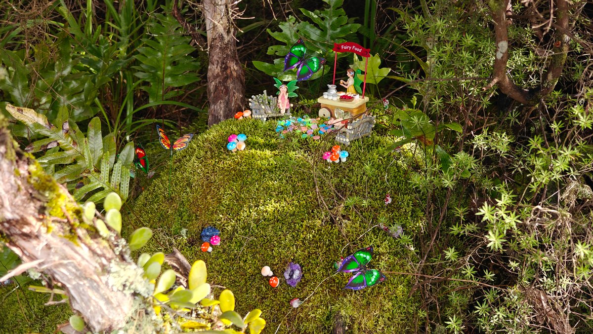 Miniature houses arranged in the moss