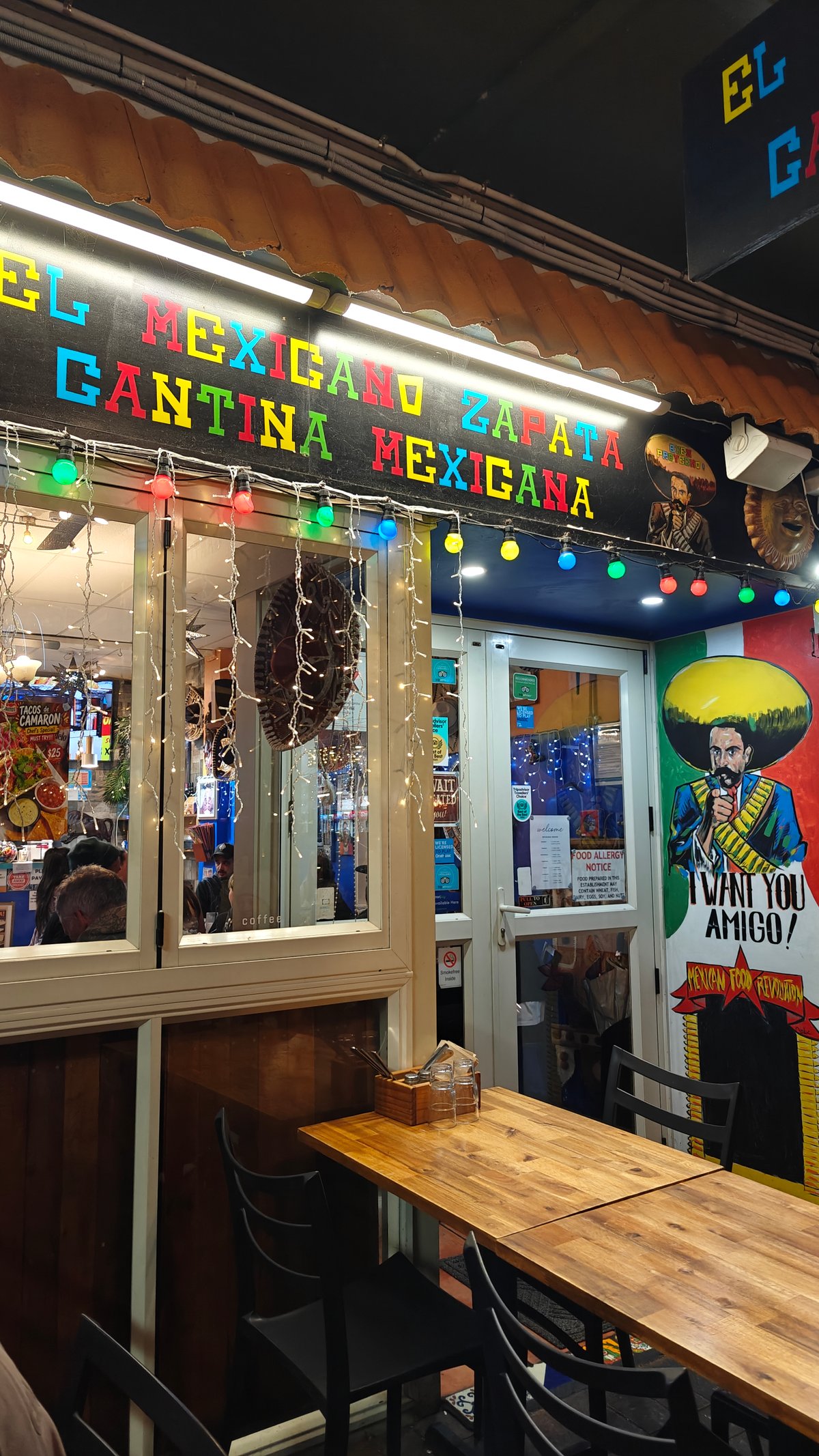 Neon cantina sign over tables