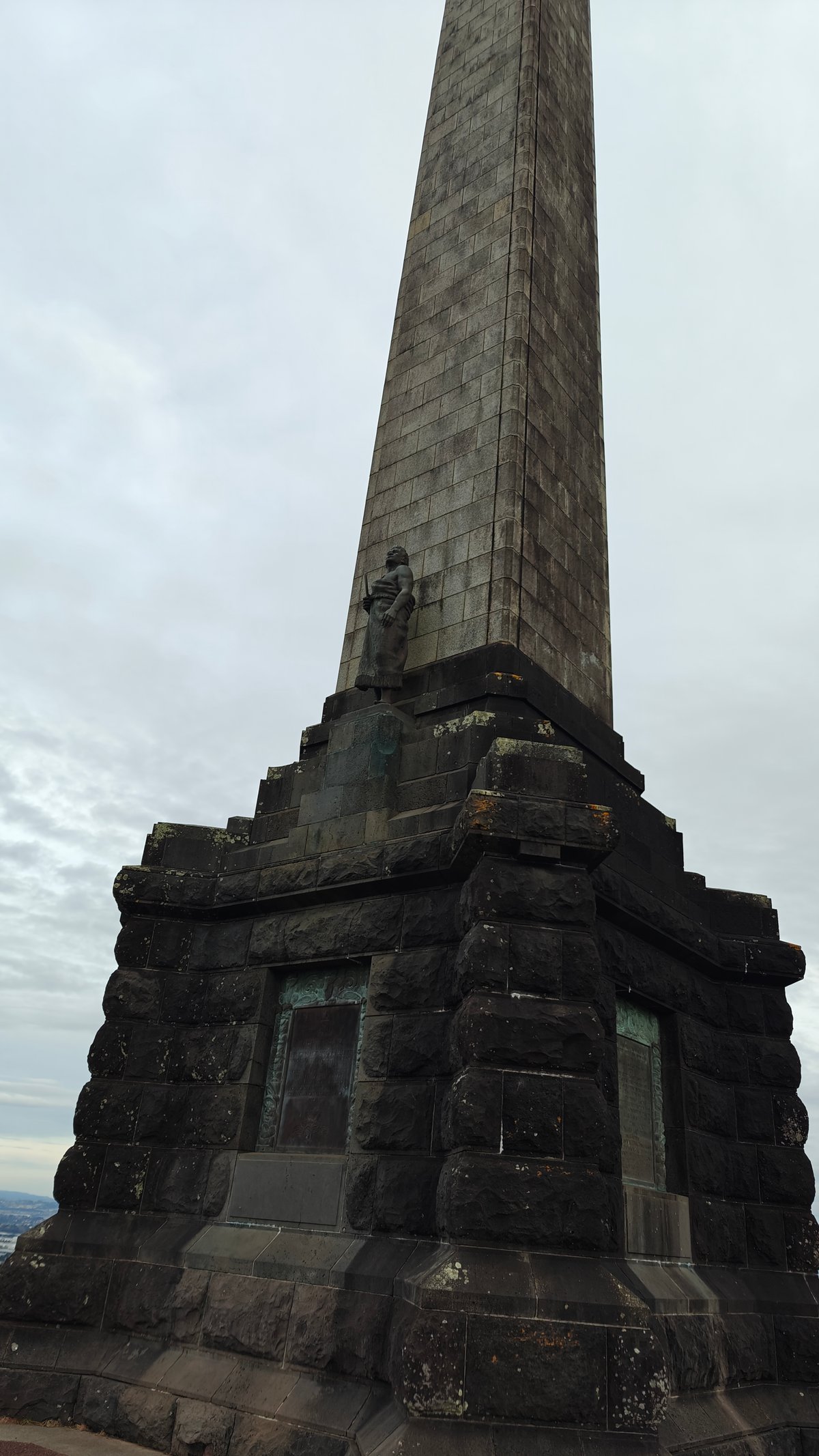Obelisk and bronze figure from below